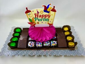 This festive, fun & sweet chocolate Purim gift arrangement comes with handcrafted foiled bon bons, rainbow chip truffle squares,chocolate bar minis & much more.